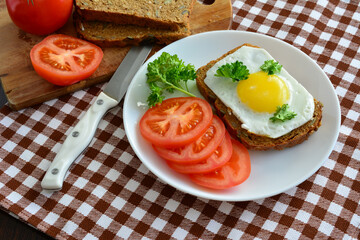 healthy snack with toast with fried egg and vegetables on plate