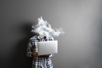 male employee working on computer with a cloud on the head