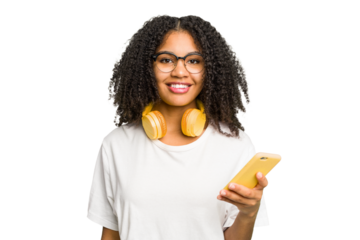 Young african american woman listening to music with headphones isolated