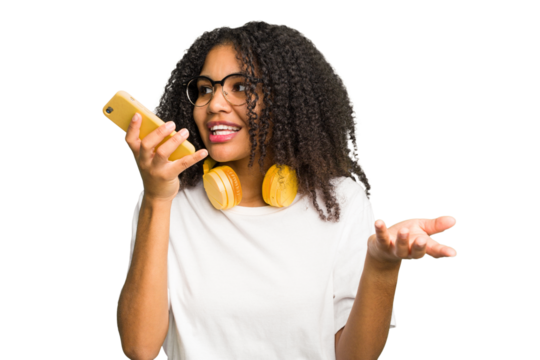 Young african american woman listening to music with headphones isolated