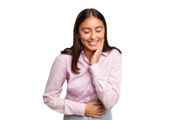 Young cute caucasian woman isolated laughs happily and has fun keeping hands on stomach.