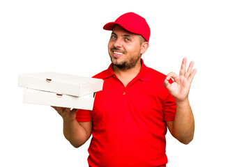 Pizza delivery caucasian man with work uniform picking up pizza boxes isolated cheerful and confident showing ok gesture.