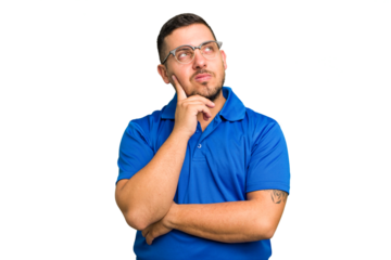 Young caucasian man isolated contemplating, planning a strategy, thinking about the way of a business.