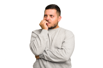 Young caucasian man isolated biting fingernails, nervous and very anxious.