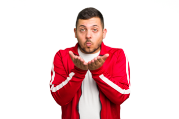 Young caucasian man isolated folding lips and holding palms to send air kiss.