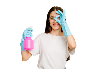 Young cleaner woman isolated excited keeping ok gesture on eye.