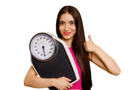 Young caucasian woman holding a scale isolated smiling and raising thumb up