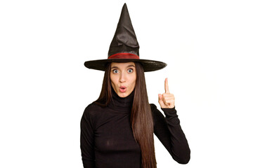 Young caucasian woman dressed as a witch for halloween day isolated having some great idea, concept of creativity.