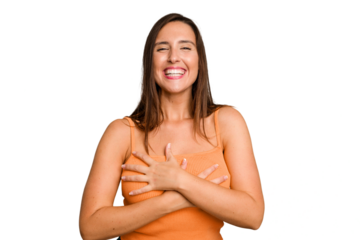 Young caucasian cute woman isolated laughs happily and has fun keeping hands on stomach.