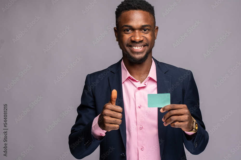 Wall mural young black businessman showing a blank card