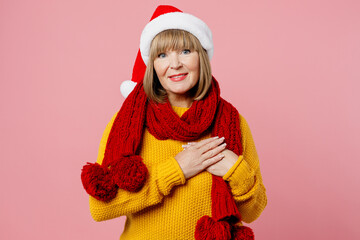 Merry thankful fun elderly woman 50s years old wear yellow knitted sweater red scarf Santa hat...