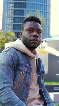 Portrait of a serious black man looking at camera on denim jacket