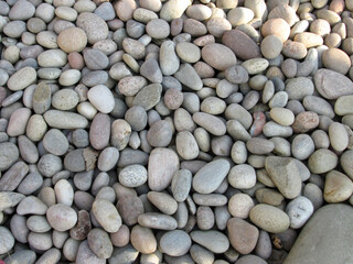 Overhead shot of a mass of rounded pebbles on a beach