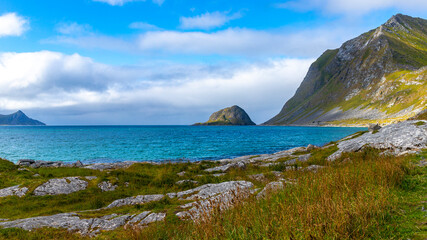 Fototapeta na wymiar paradise beach amidst the mighty norwegian cliffs, famous haukland beach in the lofoten islands, norway; beach in the norwegian fjord