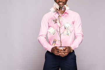 young african man behind a money tree