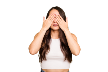 Young caucasian woman isolated on green chroma background afraid covering eyes with hands.