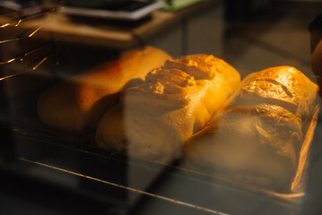 Three bread rolls baked in the oven until toasted with crunchy crust