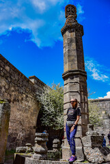 A girl near the swinging pillar of Gavazan on the territory of the Tatev monastery of the 9th...
