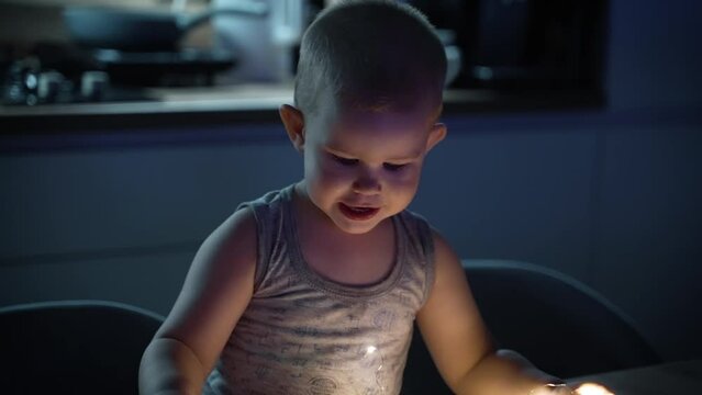 Snotty kid spoiling at the kitchen table with swag.