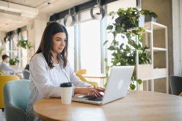 Smiling girl student study online with skype teacher, happy young woman learn language listen...