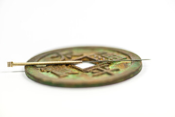 acupuncture needle on chinese antique coin