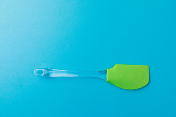  silicone green spatula with plastic handle on color background- Image