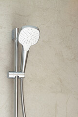 The new shower head in the bathroom to spray water fixed on the wall