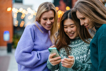 Group of friends in the street with smartphone
