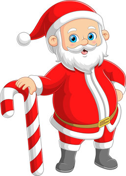 The Santa claus is standing and posing while holding a big candy cane