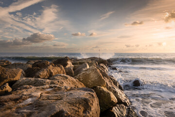 Fototapeta na wymiar Southbourne Dorset, boulder sea defence with waves, landscape