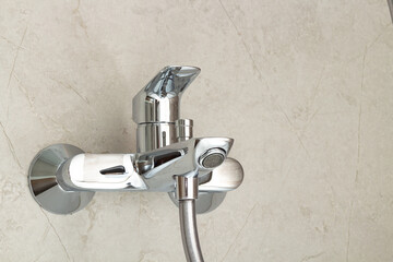 Close-up of a new water faucet located on the wall