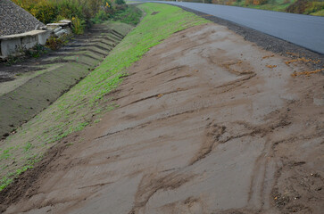 A newly built road, on the layer of which you can see successive layers of screed and asphalt...