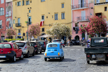 Italian little car fiat 500 blue in the streets of Procida Naples in Italy