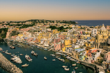 Procida island, Naples, Italy, colorful houses in Marina di Corricella harbour in sunset light