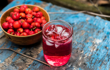 Glass of sour cherry juice with fresh red cherries, Cherry juice, on wood background, red drink,...