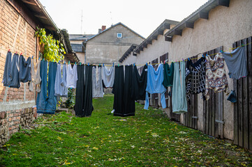 washed laundry pegged out on a washing line in the court yard on a cloudy day