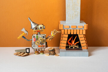Toy robot has prepared firewood for the winter heating period, is posing with an ax, a saw and a...