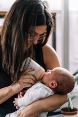 Mother feeding her newborn baby from a bottle