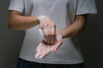 Lady washing hand rubbing with soap to prevent the spread of bacteria and virus. Personal hygiene...