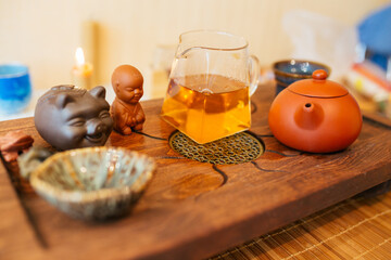  Chinese tea ceremony on bamboo table. Ceramic tea cups and clay teapot close-up. 