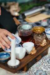  Chinese tea ceremony on bamboo table. Ceramic gaiwan and tea cups  close-up. 