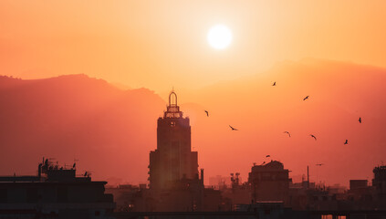 Obraz premium Old Apartment Buildings in Urban Downtown City with Mountains in Background. Palermo, Sicily, Italy. Dramatic Sunset Sky