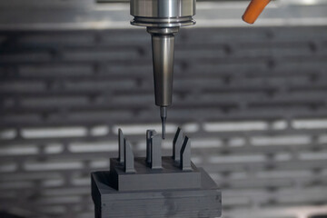 The CNC milling machine cutting the graphite electrode parts with solid ball end mill.