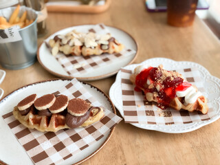 croffle with berries and chocolate topping and cake strawberry topping