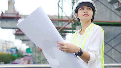 Civil engineer woman onsite to inspection construction over the road