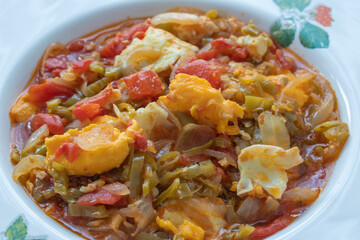 Traditional turkish food menemen made by eggs and tomatoes.