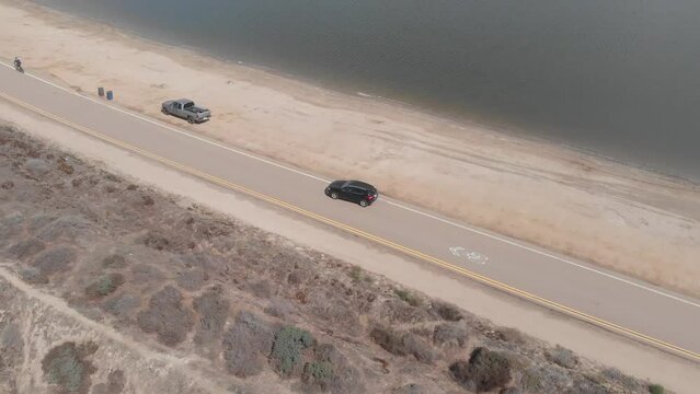 Drone shot with car in Fiesta Island Park, San Diego