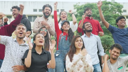 Group of audience at stadium cheering players by clapping and shouting the name while watching sports match - concept of encouragement, cooperation and freedom.