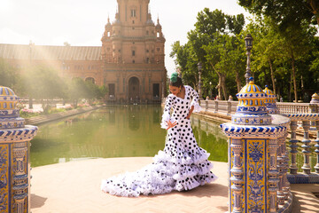 Flamenco dancer woman, beautiful brunette teenager dressed in typical costume with ruffles and...