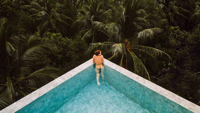 Woman chilling in pool on tropical resort